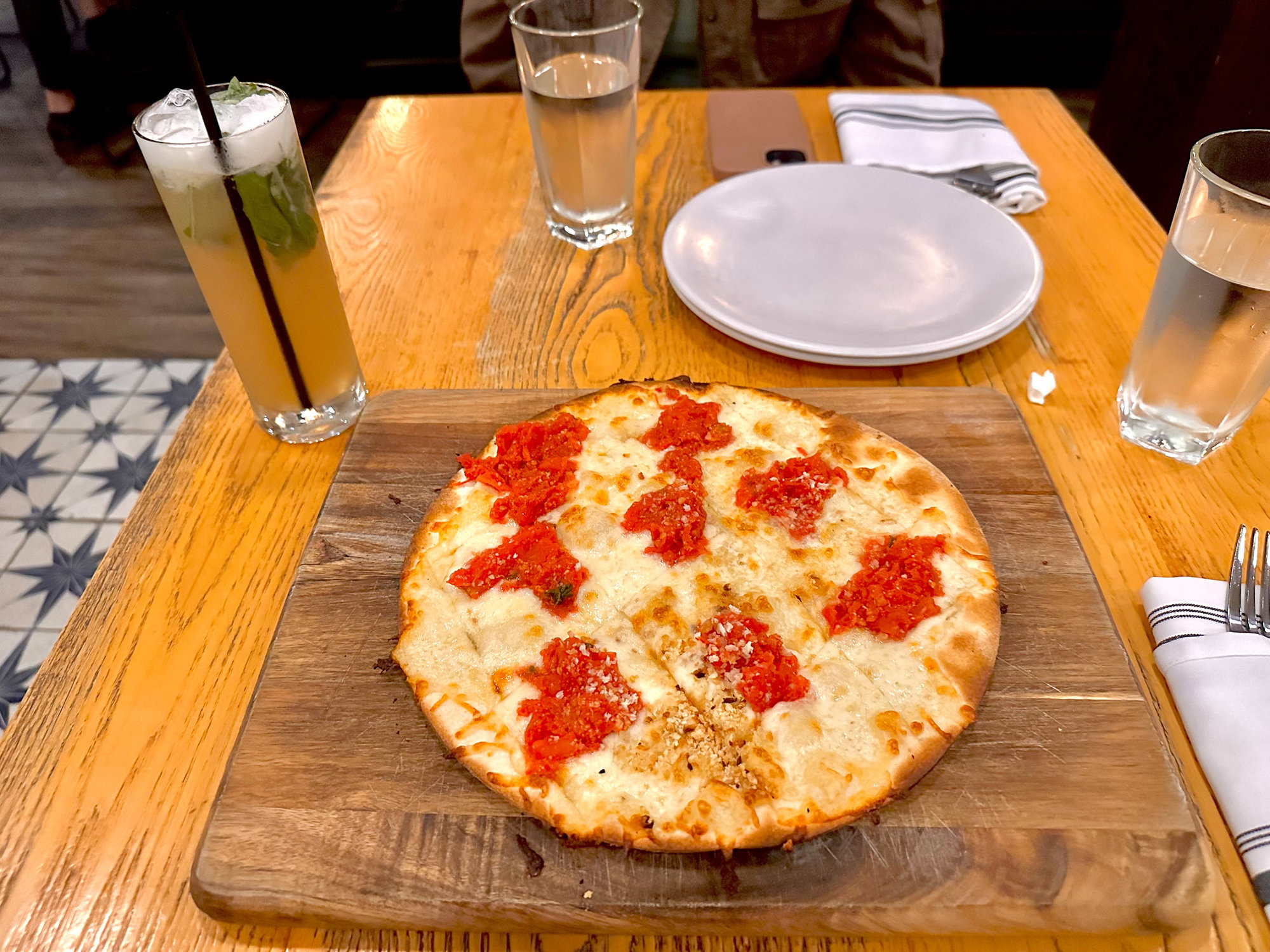 Delicious flatbread on table with drinks